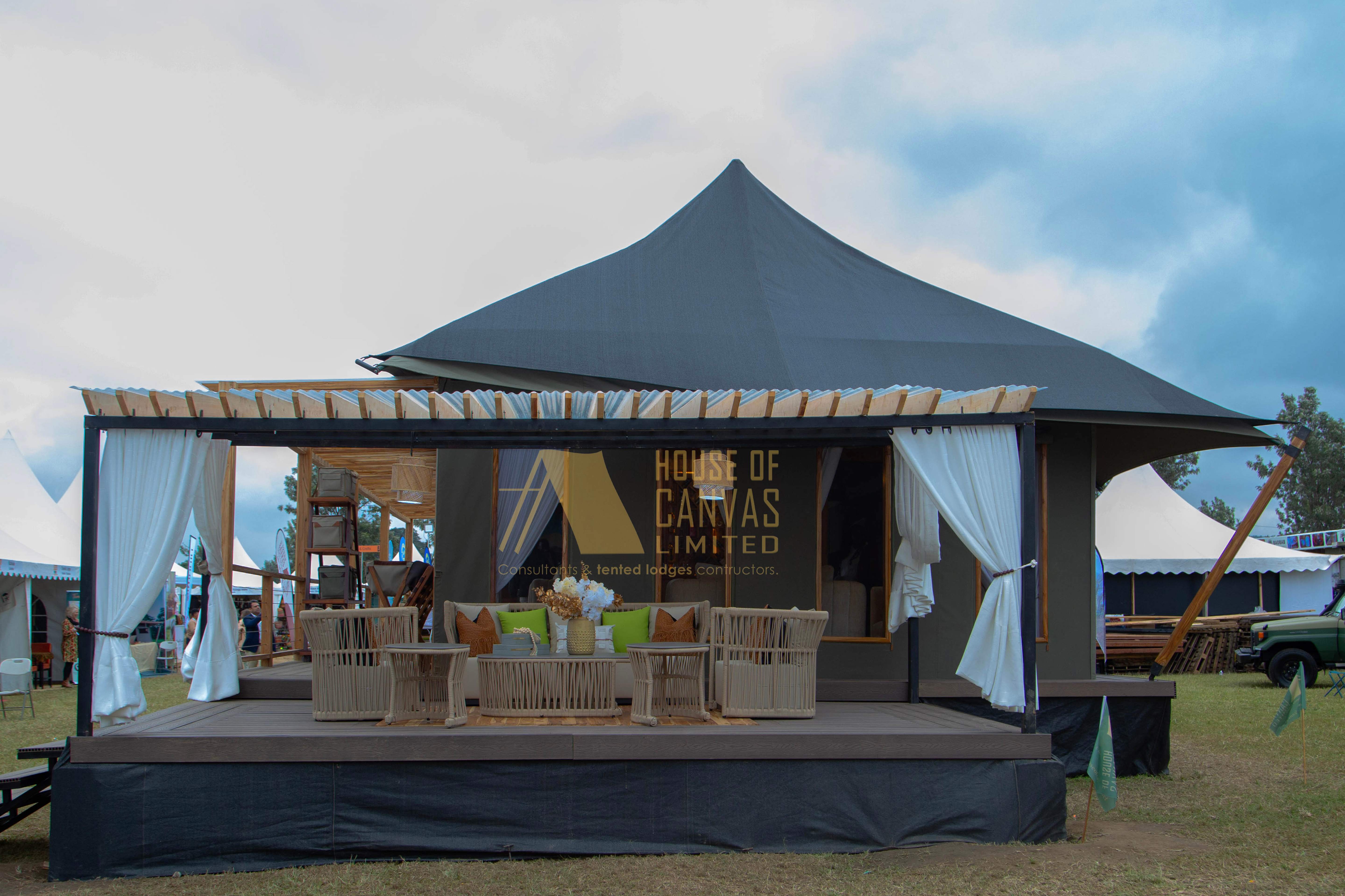 House of Canvas exhibition tent with professional branding and outdoor seating setup