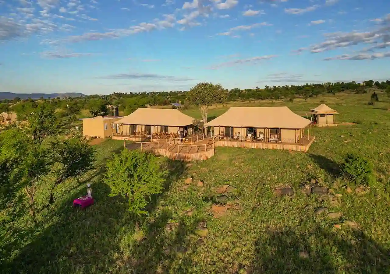 Aerial view of complete safari lodge complex with multiple structures