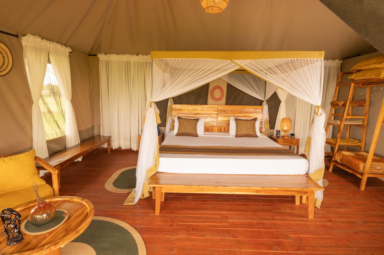 Elegant safari tent with four-poster bed and traditional African decor