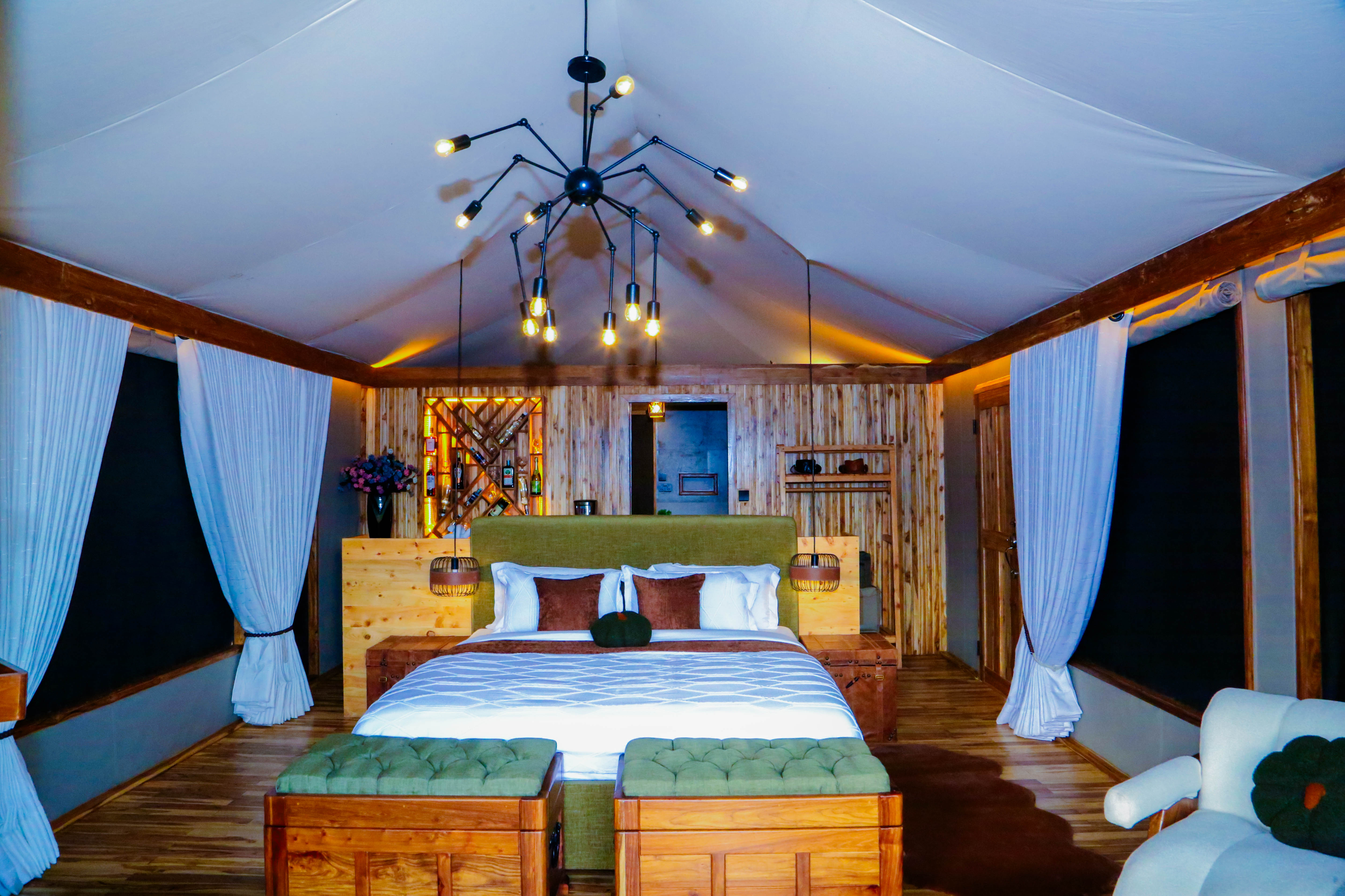Luxurious bedroom with wooden wine rack feature wall and dramatic lighting