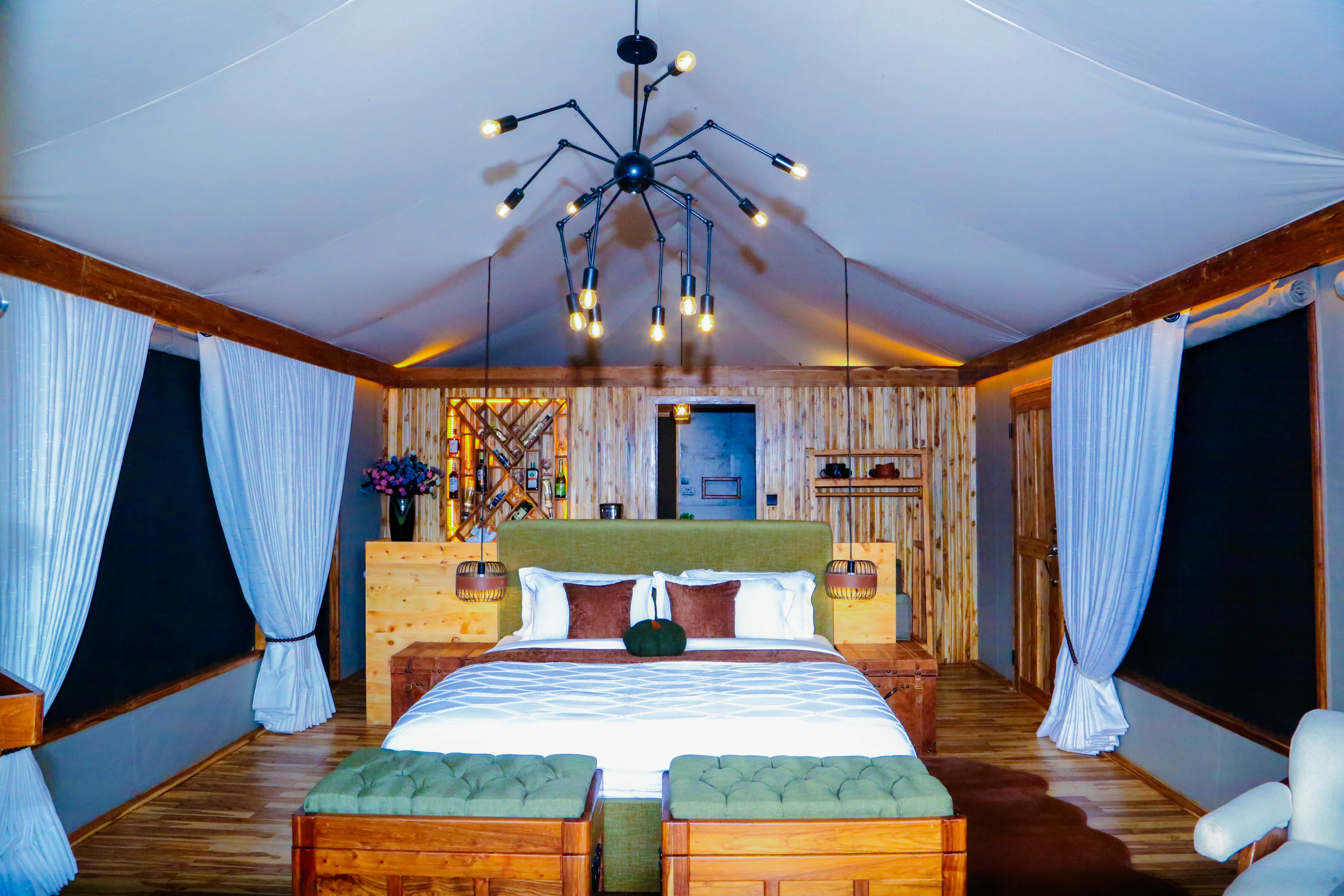 Luxurious bedroom with wooden wine rack feature wall and dramatic lighting