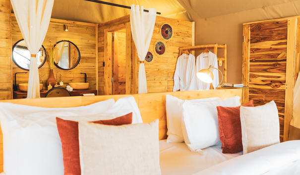 Luxury tent bathroom with modern fixtures and warm wood finishes