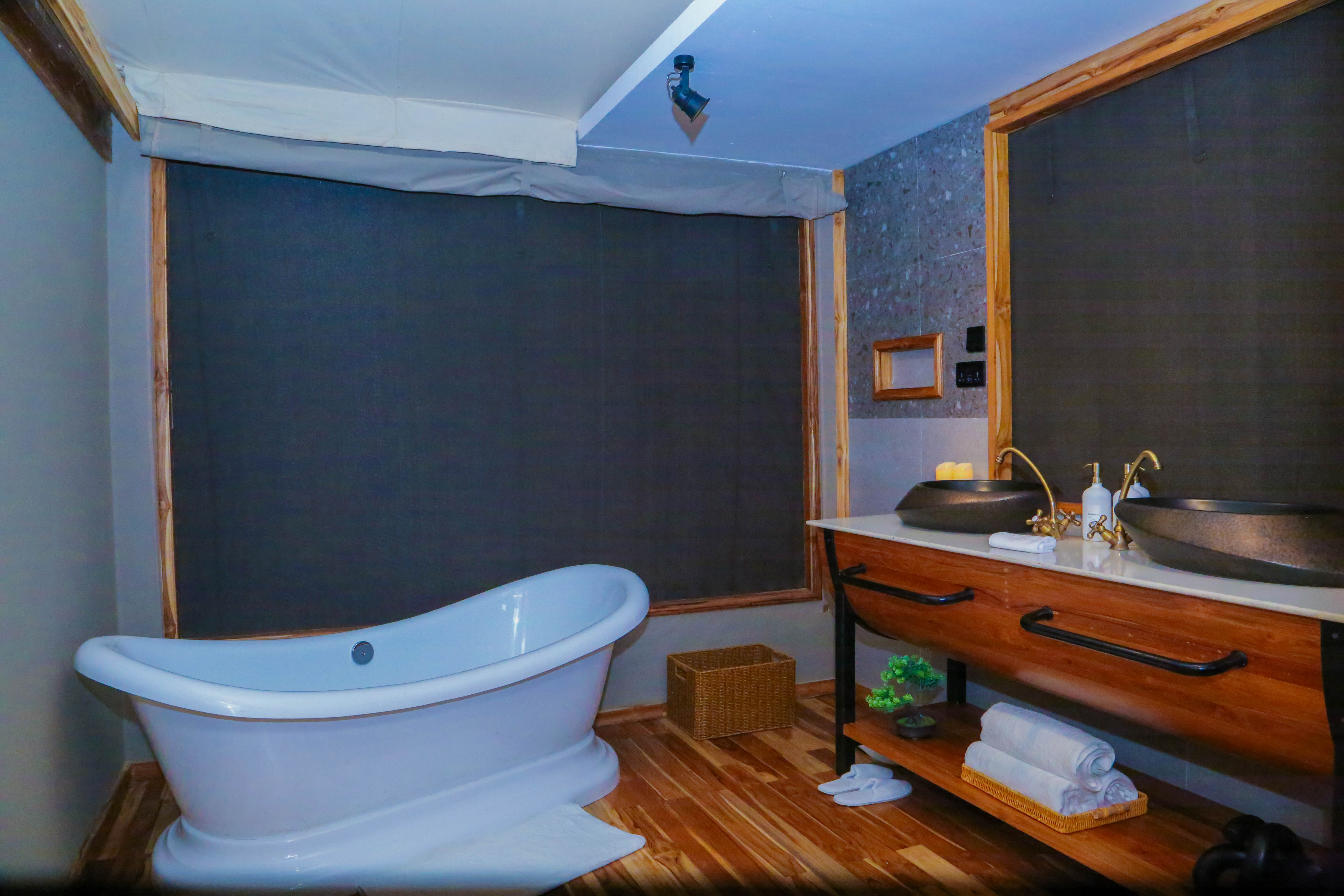 Modern bathroom with freestanding white bathtub and wooden vanity