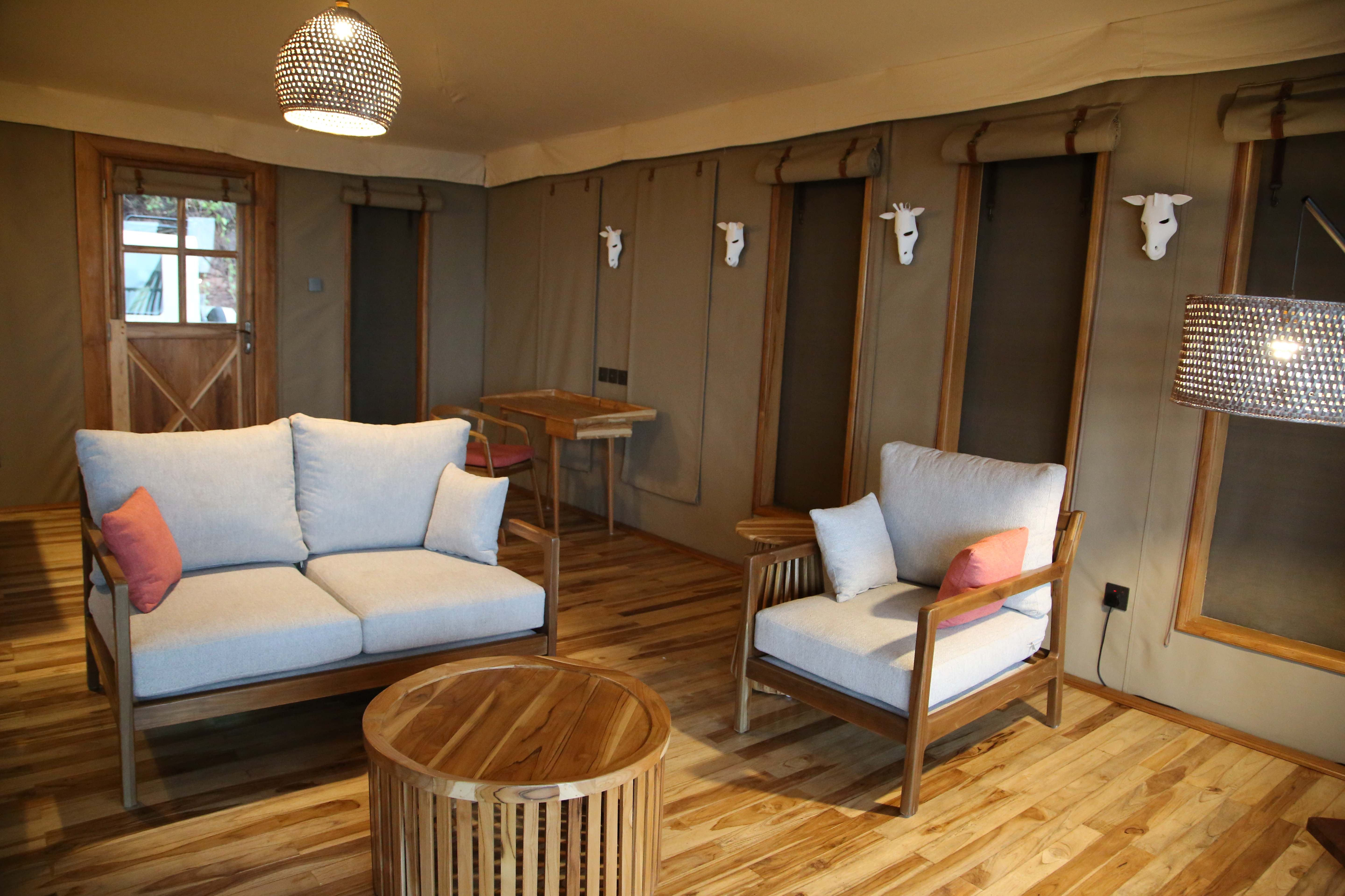 Rustic living room with wooden paneling and neutral furniture