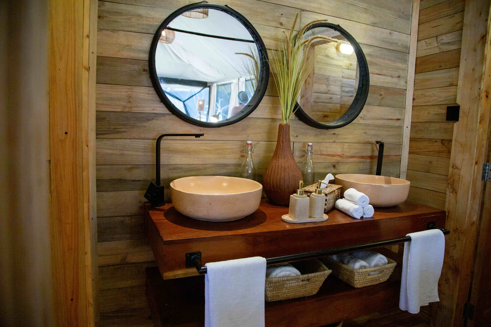 Luxury bathroom with dual vessel sinks and rustic wooden wall paneling