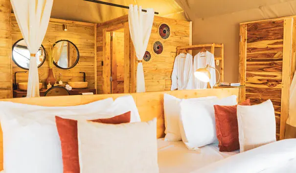 Luxury tent bathroom with modern fixtures and warm wood finishes