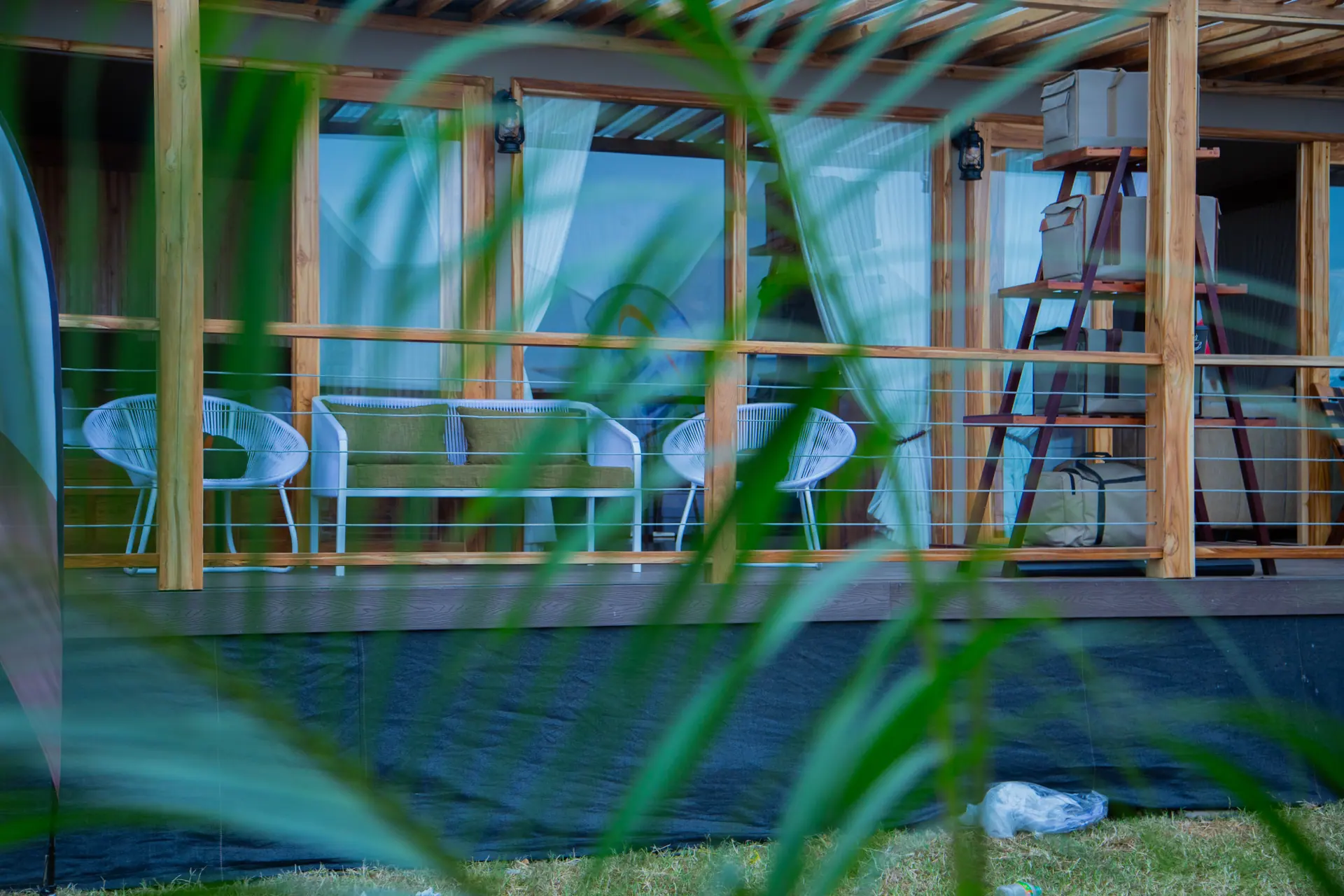 Deck seating seen through foliage