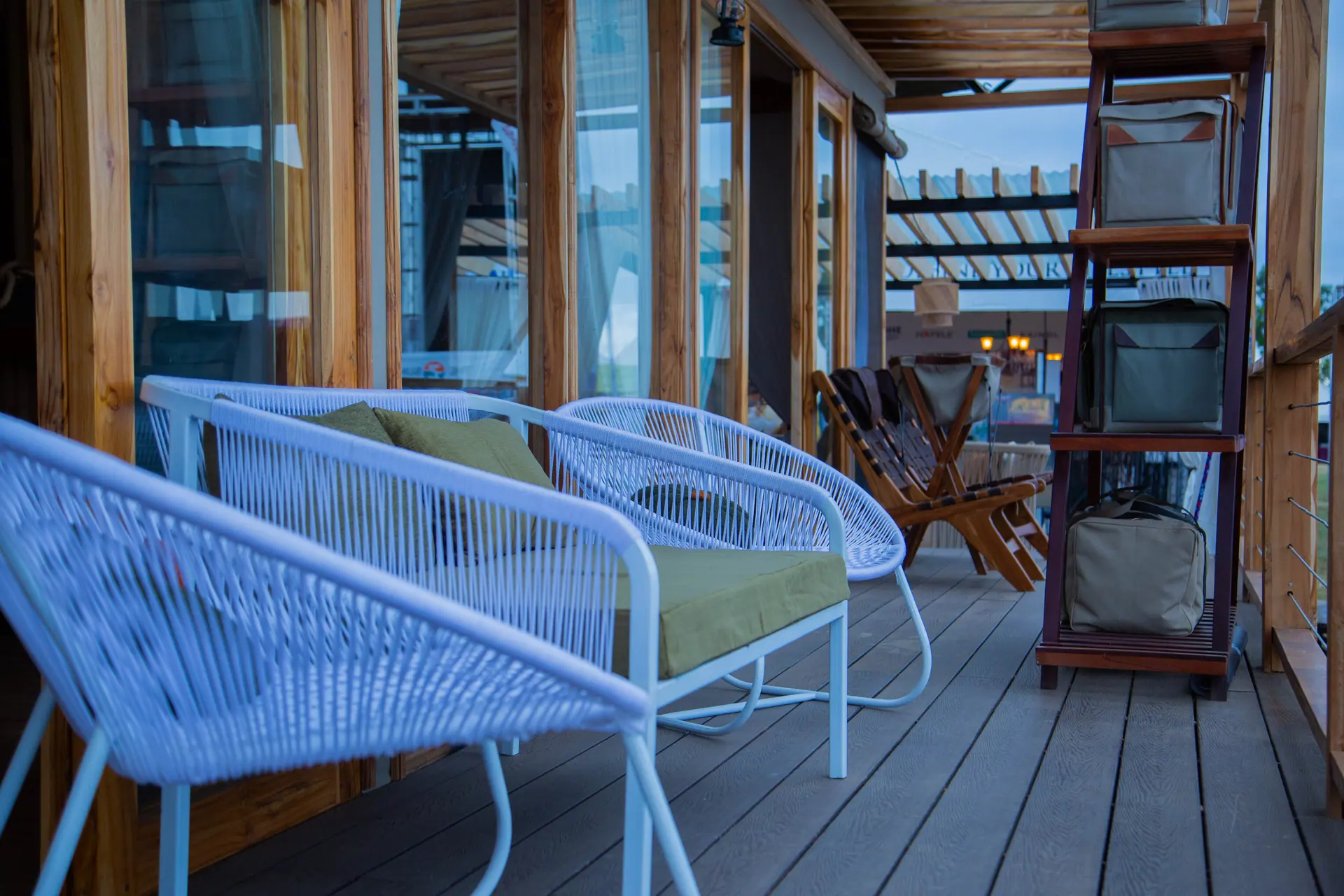 Deck with white chairs and green cushions