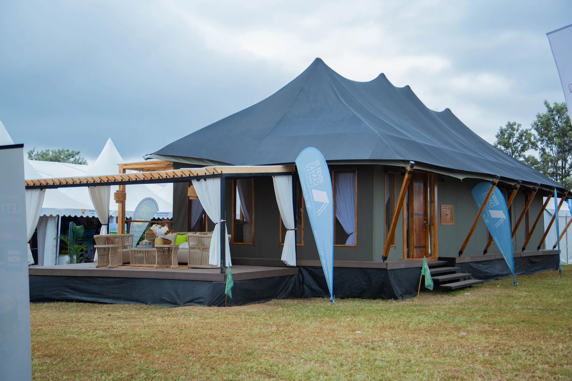 Full exhibition tent setup with outdoor seating