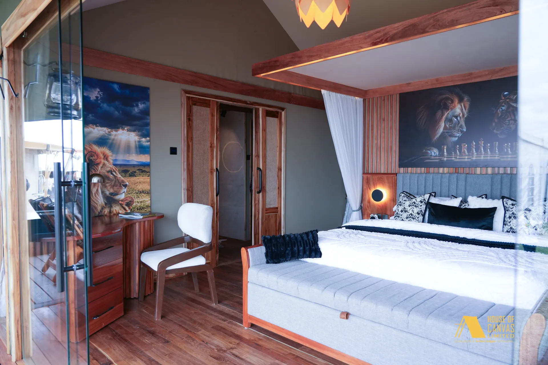 Bedroom suite at Kili Fair 2026 with glass entry, writing chair and lion canvas
