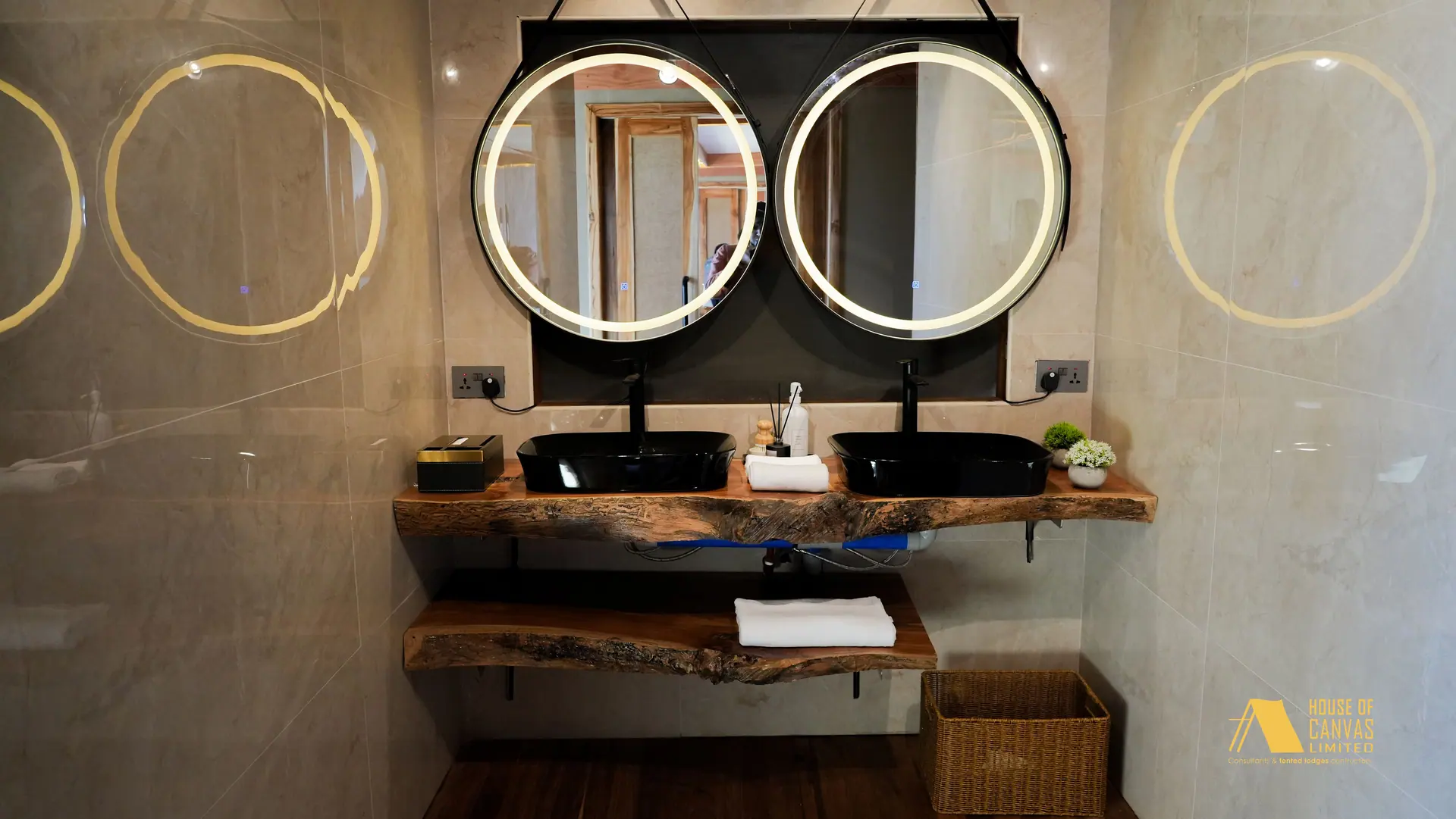 Twin backlit round mirrors above a live-edge timber vanity at Kili Fair 2026